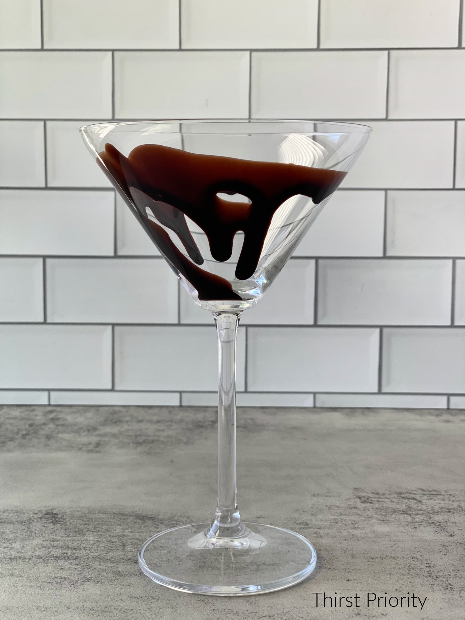 chocolate syrup drizzle in martini glass 